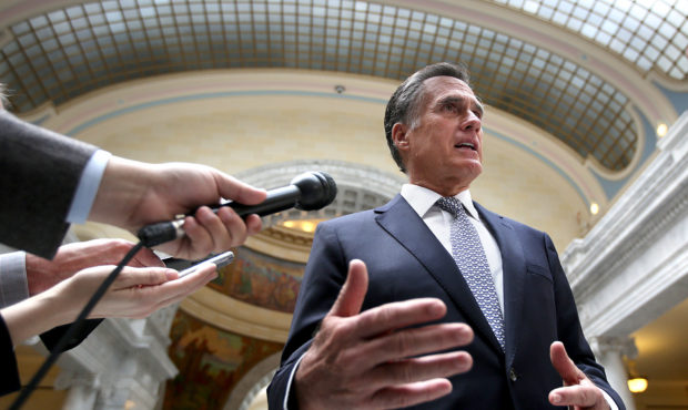 FILE - Mitt Romney talks to the media after addressing House and Senate Republicans during their ca...