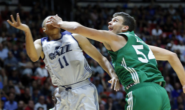 Ante Zizic of Boston fouls Dante Exum of Utah during NBA summer league basketball at the Huntsman C...