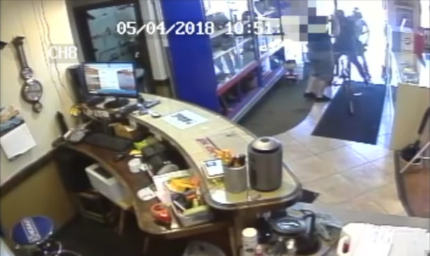 A still frame from surveillance camera video of an armed robbery at Bountiful Pawn on May 4, 2018. ...