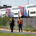 Workers return to a FrontRunner train after officials investigate a suspicious package on the train just north of Station Park in Farmington on Saturday, July 7, 2018. (Ravell Call, Deseret News)