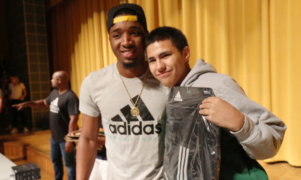 Utah Jazz player Donovan Mitchell poses for a photo of Kearns High student Jason Madera after givin...