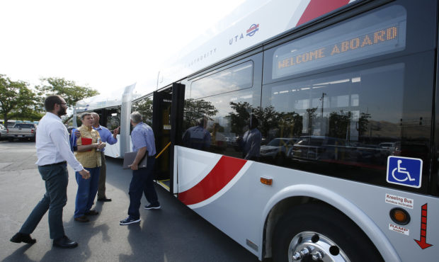 UTA employees look over the New Flyer Xcelsior 60-foot articulated bus in Salt Lake City on Friday,...