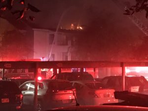 The early morning apartment fire raged and injured two people
