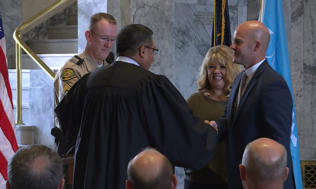Judge Darold J. McDade shakes the hand of Michael Smith after Smith is sworn in as the new Utah Cou...