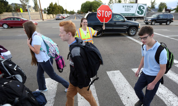 Crossing guard Heather Childs helps students cross the street near Hawthorn Academy and Westvale El...