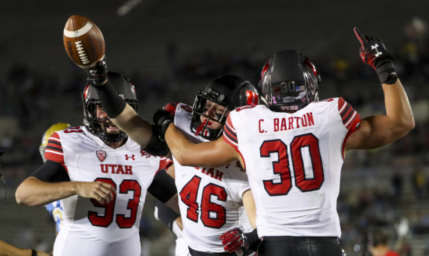 Utah Utes tight end Connor Haller (46) holds up the ball after scooping up a muffed punt by UCLA du...