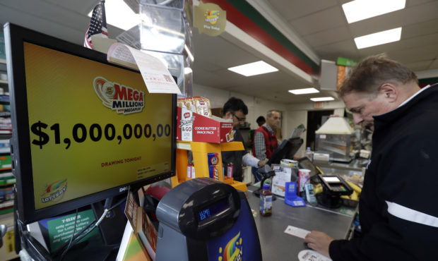 A sign displays the estimated Mega Millions jackpot at a convenience store in Chicago, Friday, Oct....