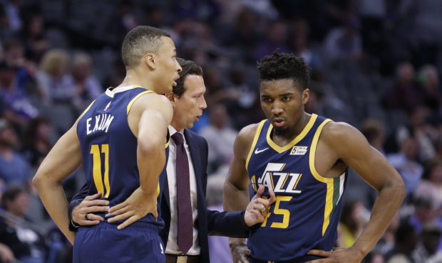 Utah Jazz coach Quin Snyder huddles with guards Dante' Exum, left, and Donovan Mitchell during the ...