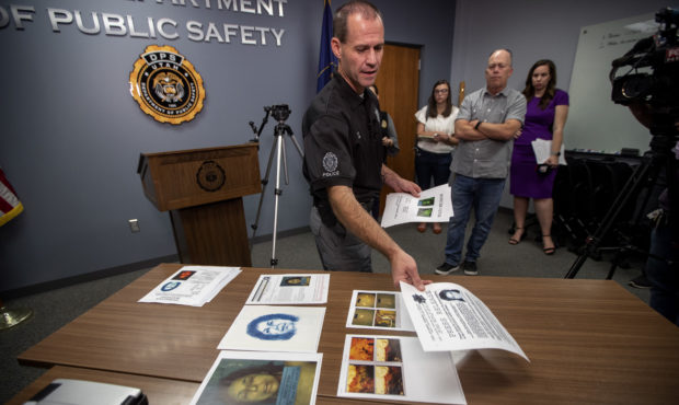 Agent Brian Davis, of the State Bureau of Investigation shows photos of the victim and the location...
