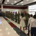Major Brent Taylor's daughter accepts handshakes from Utah National Guard members at Orion Jr. High School.