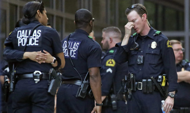 File photo Dallas Police officers comforting each other after a shooting. (Louis DeLuca/The Dallas ...