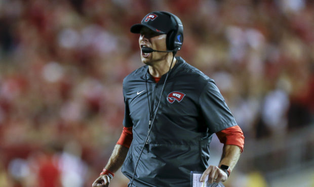 Western Kentucky coach Mike Sanford disputes a call during the second half of an NCAA college footb...