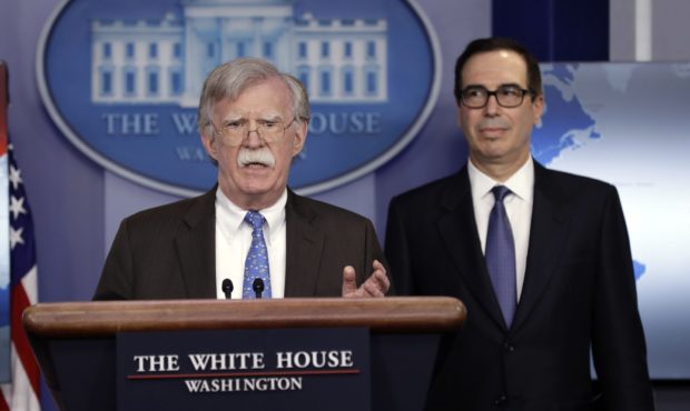National security adviser John Bolton speaks as Treasury Secretary Steven Mnuchin listens during a ...