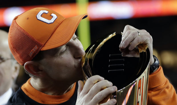 Clemson head coach Dabo Swinney kisses the championship trophy after the NCAA college football play...