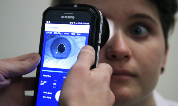 Clinical Research Assistant Kevin Jackson uses AlgometRx Platform Technology on Sarah Taylor's eyes...