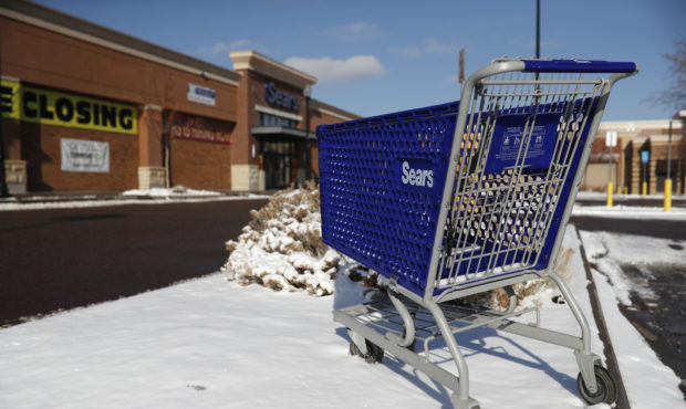 FILE- In this Tuesday, Jan. 1, 2019, file photo, an empty shopping cart sits outside a Sears store ...