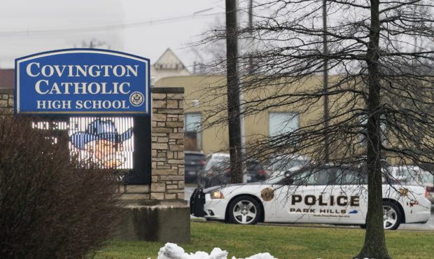 A police car sits at the entrance to Covington Catholic High School in Park Hills, Ky., Saturday, J...