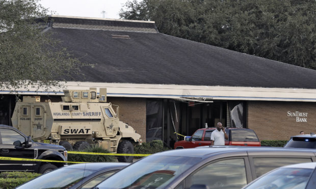 A Highlands County Sheriff's SWAT vehicle is stationed out in front of a SunTrust Bank branch, Wedn...