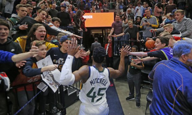 Fans reach for Utah Jazz guard Donovan Mitchell (45) following the team's NBA basketball game again...