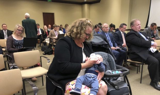 ormer Utah County Commission candidate Teri McCabe feds her child during a confetti meeting at the ...