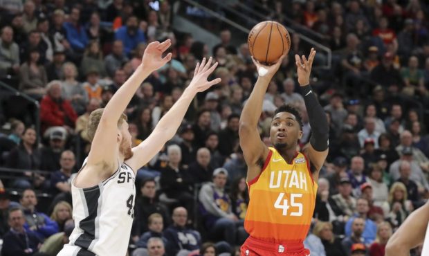 Utah Jazz guard Donovan Mitchell (45) shoots past the arms of San Antonio Spurs forward Davis Berta...