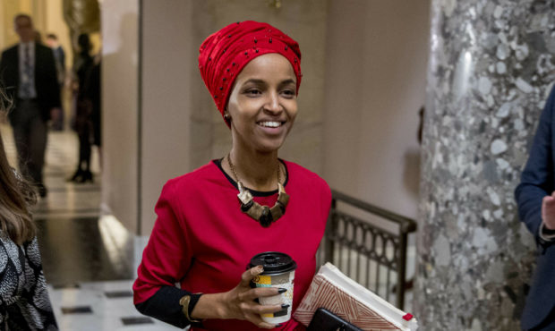 In this Jan. 16, 2019 file photo, Rep. Ilhan Omar, D-Minn., center, walks through the halls of the ...