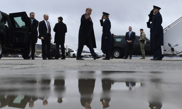 President Donald Trump waves as he arrives to board Air Force One at Andrews Air Force Base in Md.,...
