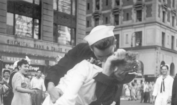 FILE - In this Aug. 14, 1945 file photo provided by the U.S. Navy, a sailor and a woman kiss in New...