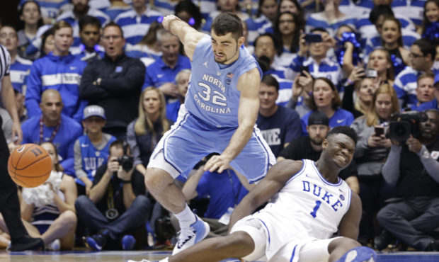 Duke's Zion Williamson (1) falls to the floor with an injury while chasing the ball with North Caro...