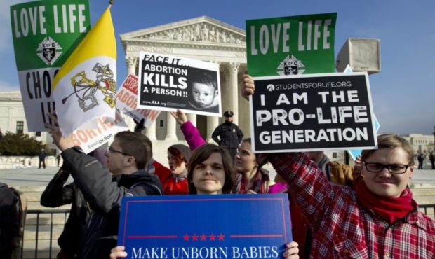 FILE - In this Friday, Jan. 18, 2019 file photo, anti-abortion activists protest outside of the U.S...