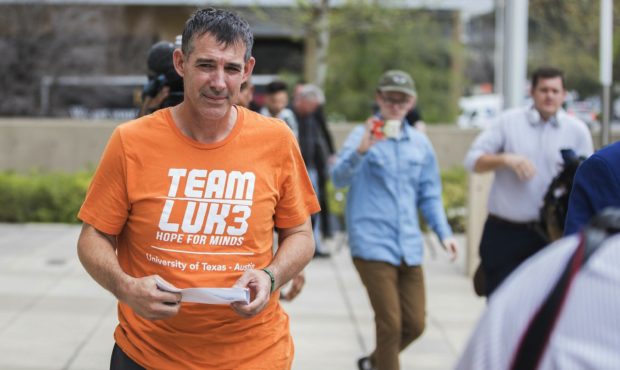 Texas men's tennis coach Michael Center walks with Defense lawyer Dan Cogdell away from the United ...