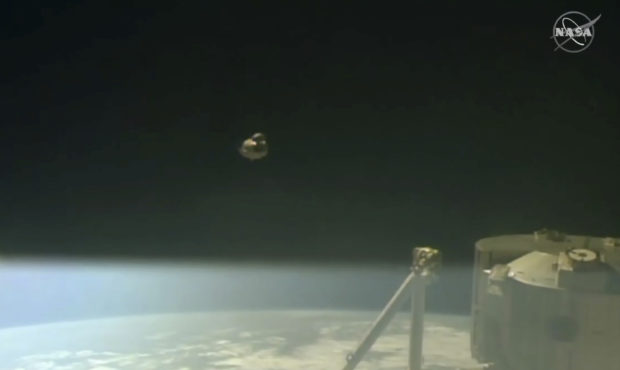 In this image taken from NASA Television, SpaceX's swanky new crew capsule, center, takes off after...