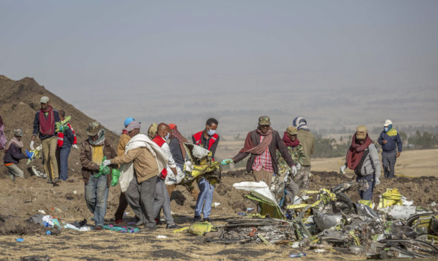 Rescuers work at the scene of an Ethiopian Airlines flight crash near Bishoftu, or Debre Zeit, sout...