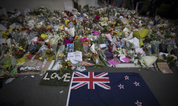 Mourners lay flowers on a wall outside the Al Noor mosque in Christchurch, New Zealand, Monday, Mar...