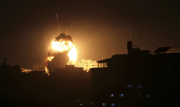 An explosion caused by Israeli airstrikes is seen from the offices of Hamas leader Ismail Haniyeh, ...