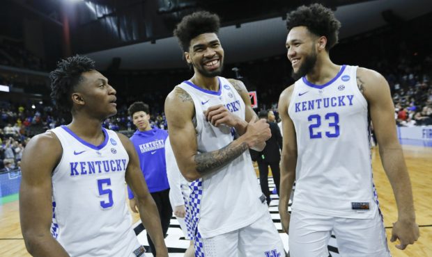 Kentucky's Immanuel Quickley (5), Nick Richards, center, and EJ Montgomery (23) smile as they leave...