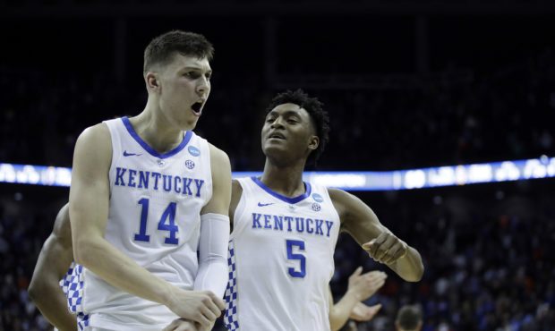 Kentucky's Tyler Herro (14) and Immanuel Quickley celebrate following a men's NCAA tournament colle...