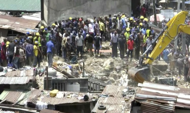 In this image taken from video rescue workers and emergency teams work at the scene of a building c...