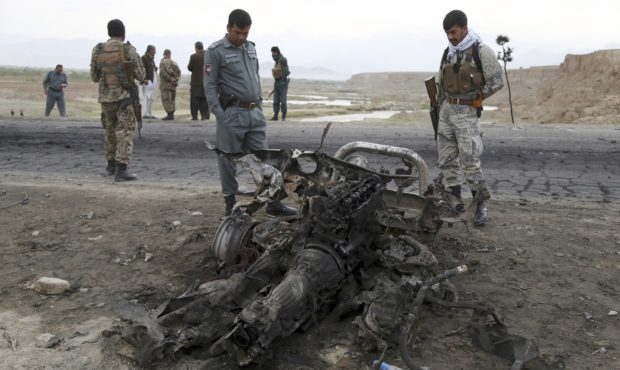 Afghan security forces gather at the site of Monday's suicide attack near the Bagram Air Base, nort...