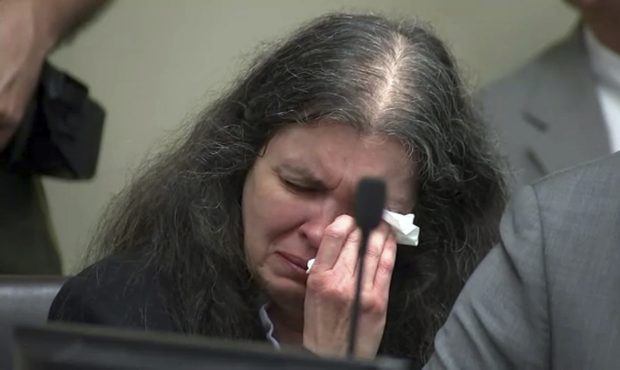 In this photo from video by KABC-TV, Louise Turpin sobs and dabs her eyes as one of her children sp...