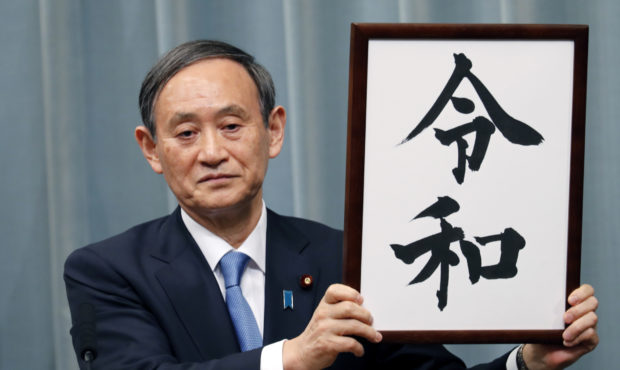 Japan’s Chief Cabinet Secretary Yoshihide Suga unveils the name of new era “Reiwa” at the pri...
