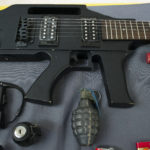 Items, prohibited on passenger airlines, and confiscated from passengers by Transportation Security Administration (TSA) officers, is displayed at Dulles International Airport in Dulles, Va., Tuesday, March 26, 2019. The items include a guitar shaped like a semi-automatic rifle, an inert grenade, and a stun gun. So far, TSA screeners have seized 65 firearms at the security checkpoint in SLC in 2019. (AP Photo/Cliff Owen)