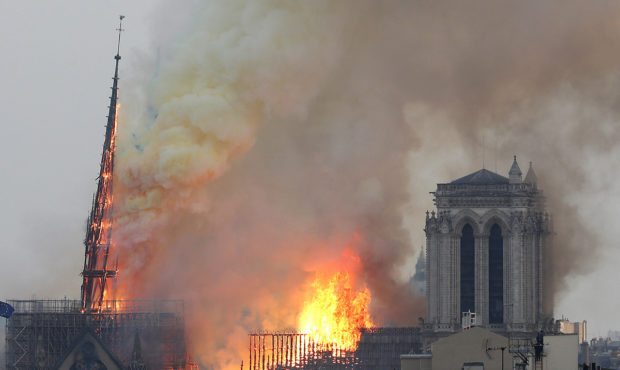 Flames rise from Notre Dame cathedral as it burns in Paris, Monday, April 15, 2019. Massive plumes ...
