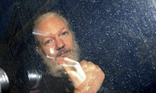 Julian Assange gestures as he arrives at Westminster Magistrates' Court in London, after the WikiLe...