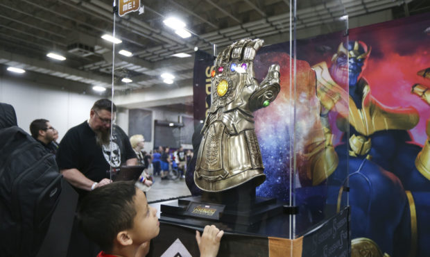 Cesar Revero, 6, looks at a display of the Infinity Gauntlet seen in the film Avengers: Infinity Wa...