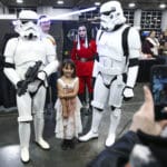 Rachel Glock, 8, has her photo taken with storm troopers during the FanX Spring Comic Convention at the Salt Palace Convention Center in Salt Lake City on Friday, April 19, 2019.