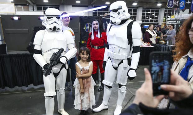 Rachel Glock, 8, has her photo taken with storm troopers during the FanX Spring Comic Convention at...
