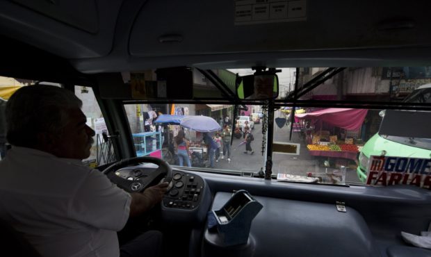 In this May 15, 2019 photo, a driver maneuvers through the narrow streets of San Miguel Teotongo on...