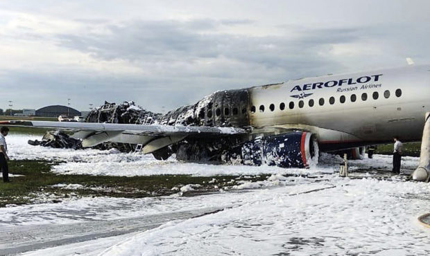 The Sukhoi SSJ100 aircraft of Aeroflot airlines is covered in fire retardant foam after an emergenc...