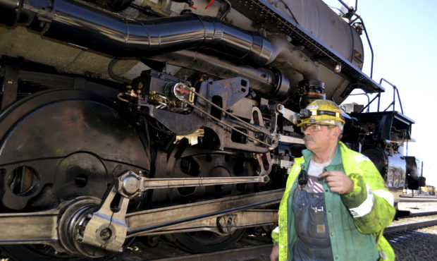 A worker walks past the wheels on the Big Boy No. 4014 at a Union Pacific restoration shop at the C...